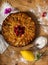 Top view of apple pie with raspberries heart over wooden board