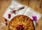 Top view of apple pie with raspberries heart over wooden board