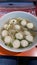 Top view Asian noodles, meatballs and bean sprouts, delicious pork broth in cups, Asian food concept.