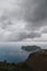 A top view at Asos village and Assos peninsula from a road during the bad weather conditions, thunderstorm and rain, with low dark