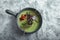 Top view asparagus soup with octopus in a gray bowl on a concrete marble gray background. Copy space, food photo