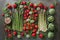 Top view of asparagus, strawberries, peas, and artichokes arranged on table