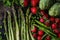 Top view of asparagus, strawberries, peas, and artichokes arranged on table