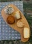 Top view of assorted cheeses on a rustic wooden board. Blue cheese, cured cheese, Manchego cheese, smoked cheese