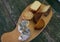 Top view of assorted cheeses on a rustic wooden board. Blue cheese, cured cheese, Manchego cheese, smoked cheese