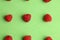 Top view of assorted delicious fresh raspberries on a green background