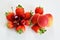 Top view of assorted fruits strawberries apricot cherries on a white background