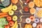 top view of assorted junk food, fresh fruits with vegetables and measuring tape on wooden