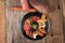 Top view of an assortment of cold appetizers served on a black plate