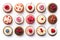 Top view of the assortment of many different cupcakes with colorful frosting and berries on white table background