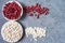 Top view of assortment of white and red beans over gray background