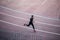 Top view Athlete running on running track. Runner sprinting on red running track in stadium