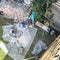 Top view of authentic builder men working with shovel during concrete cement solution mortar preparation in mixer at