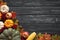 Top view of Autumn maple leaves with Pumpkin and red berries on old wooden backgound.