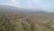 Top view of autumn misty forest in mountains. Shot. Panorama of mountains in fog and agricultural fields in autumn