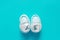 Top view of baby boy booties on pastel blue background