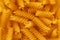Top view on background texture of uncooked fusilli pasta.