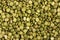 Top view on background texture of uncooked green split peas.