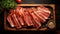 Top View Of Bacon Slices On Dark Wooden Table