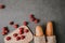 top view of baguettes in paper bags, fresh tomatoes and wooden board on grey