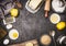 Top view of bake preparation with kitchen tools and ingredients for cake or cookies : lemon , flour, egg, raw sugar and butter on