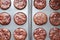 Top view on baked chocolate muffins with cherries in baking dish. Background with many cupcakes. Selective focus