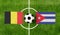 Top view ball with Belgium vs. Cuba flags match on green football field