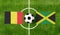 Top view ball with Belgium vs. Jamaica flags match on green football field