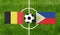 Top view ball with Belgium vs. Philippines flags match on green football field