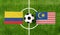 Top view ball with Colombia vs. Malaysia flags match on green football field