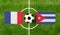 Top view ball with France vs. Cuba flags match on green football field
