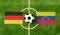 Top view ball with Germany vs. Venezuela flags match on green soccer field