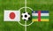 Top view ball with Japan vs. Central African Republic flags match on green football field