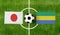 Top view ball with Japan vs. Gabon flags match on green football field