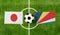 Top view ball with Japan vs. Seychelles flags match on green football field