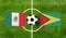 Top view ball with Mexico vs. Guyana flags match on green football field