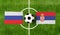 Top view ball with Russia vs. Serbia flags match on green soccer field