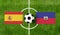 Top view ball with Spain vs. Haiti flags match on green soccer field