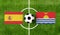 Top view ball with Spain vs. Kiribati flags match on green soccer field