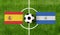 Top view ball with Spain vs. Nicaragua flags match on green soccer field