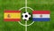 Top view ball with Spain vs. Paraguay flags match on green soccer field