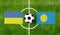 Top view ball with Ukraine vs. Palau flags match on green football field
