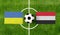 Top view ball with Ukraine vs. Yemen flags match on green football field