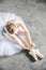 Top view at ballet dancer tying slippers around her ankle