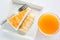 Top view of banana caramel crepe cake and orange juice on white