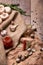 Top view of a bank of hot red peppers, spicy garlic, quail eggs and rosemary on a crumpled paper and wooden background.