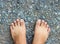 Top View of Bare Foot on Cement Floor Background.