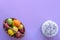 Top view on basket with easter eggs and on cake, purple background