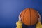 Top view of basketball on the blue background. Student holding basketball.Empty space for text