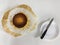 Top view of Basque burnt cheesecake and knife on a plate on white background.